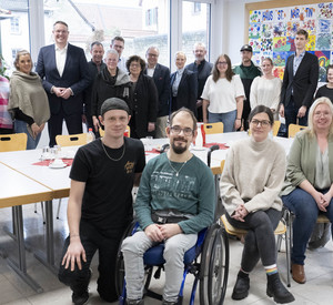 Gruppenbild mit Ministerpräsident Alexander Schweitzer und Sozialministerin Dörte Schall sowie dem Team und Bewohnerinnen und Bewohnern des Hauses St. Martin der Caritas in Ingelheim.