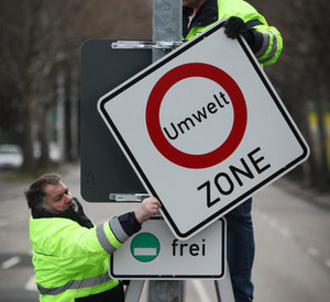 Arbeiter montieren Hinweisschild für die Umweltzone in Mainz; Bild: dpa