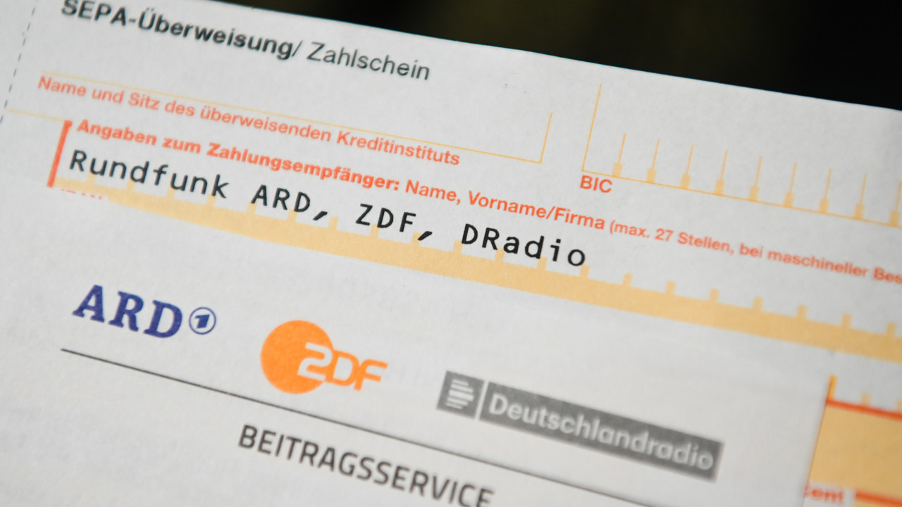 Auf einem Tisch liegt ein Anschreiben und Überweisungsträger für die Rundfunkgebühren.