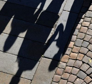 Schatten von Erwachsenen und Kindern; Bild: dpa